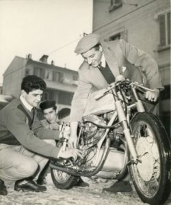 Mario Michelini e il pilota Tarquinio Provini (accosciato) con la nuova Mondial 250 bicilindrica, 1956 Famiglia Marzocchi, Archivio familiare. Foto W. Breveglieri